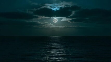 Full moon illuminates dark ocean waves under dramatic cloudy night sky