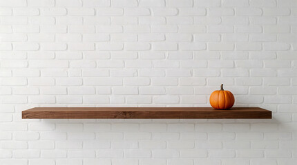 Small orange pumpkin on a rustic wooden shelf with black brackets against a white brick wall.