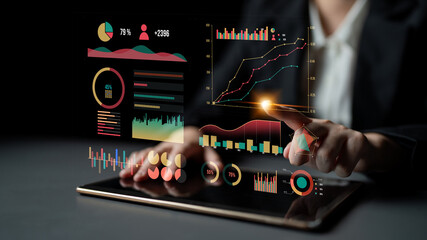A business professional interacts with a digital tablet displaying vibrant data visualizations, capturing insights from graphs and metrics in a modern office setting. Impute