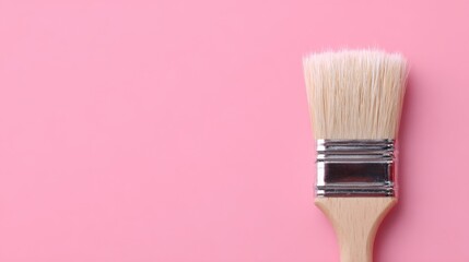 Creative Brush on Pink, a soft blonde-haired paintbrush against a vibrant pink backdrop, embodies artistry and beauty, symbolizing innovative hairstyling concepts in a minimalist setting.