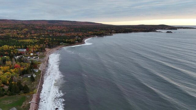 Ingonish Beach along Cabot Trail, Cape Breton, Nova Scotia, Canada. Incredible blue ocean waters with the autumn fall foliage colors.