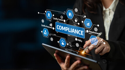 A business professional interacts with a tablet, managing compliance and quality control effectively, highlighting modern strategies in a digital workspace environment. Tessel