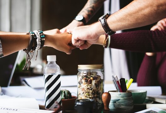 Teamwork and Success: Hands Clasped into One Fist 