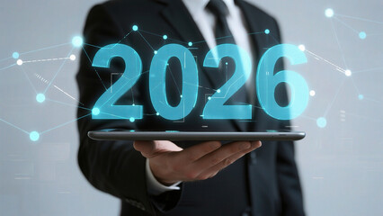 Businessman holding tablet with 2026 hologram