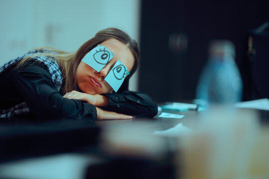 Tired Worker With Wide Eyes Drawn on Sticky Notes. Unhappy sleepy worker pretending to be awake at work
