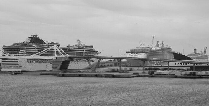 Massive Italian family cruiseship cruise ship Fantasia, Splendida or Divina in Barcelona, Spain during Summer Mediterranean cruising in sleek modern design with port infrasctructure and marine traffic
