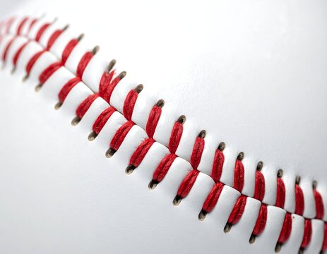 Close-up on a baseball, showing the stitching in bright red thread