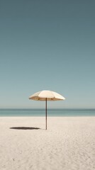 Solitary Beach Umbrella on Empty Shoreline under Clear Sky