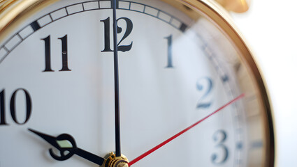Close-up of a classic golden analog clock face, with hands nearing the twelve o'clock position, symbolizing time management and deadlines.