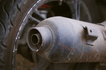 Close up of Motorcycle Exhaust Pipe and Tire on the Road