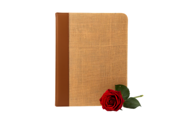 A textured journal with a single red rose on a dark background