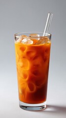 Refreshing Orange Beverage with Ice and Straw in Clear Glass
