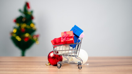 Holiday Shopping Deals Gifts in Cart with Festive Christmas Tree Background