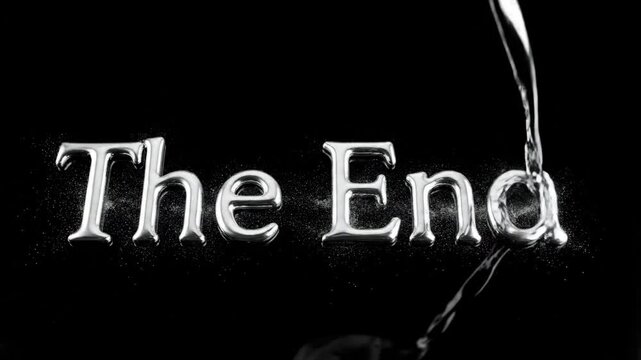 A stark monochrome close-up depicts the words "The End" in a reflective silver, seemingly being washed away by a stream of water against a black background, creating a