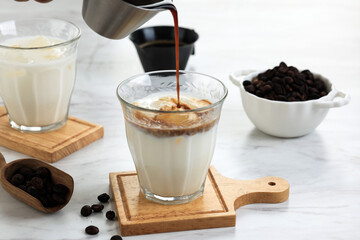 Pouring Black Coffee Shot to the Glass with Cold Fresh Milk