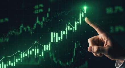 Human finger points towards bright green upward trending financial stock market graph with candlestick charts line graphs displayed on dark digital screen for growth positive performance.