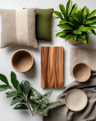Minimalist flat lay featuring greenery, cushions, and wooden elements, creating serene and inviting atmosphere
