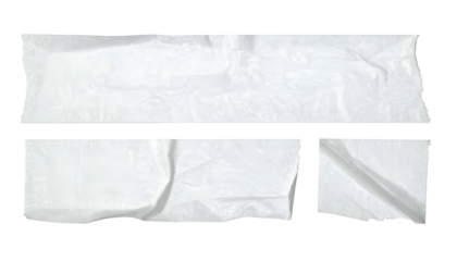 Three torn, white adhesive strips on a black background, crinkled texture visible