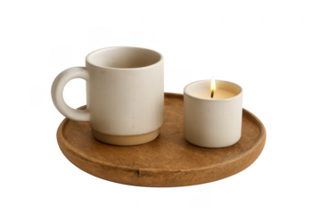 Cozy ceramic mug and lit candle on wooden tray