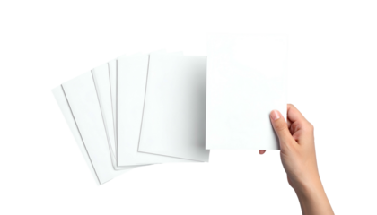 A hand holding a blank white sheet of paper over a stack of other blank papers