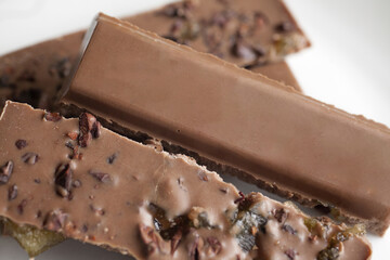 Milk chocolate candy bar with cacao nibs and fruit