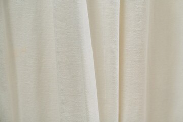 Capture the elegance of this cream-colored fabric texture, ideal for backgrounds in fashion photography or interior design. Its soft folds create a versatile backdrop for various projects.