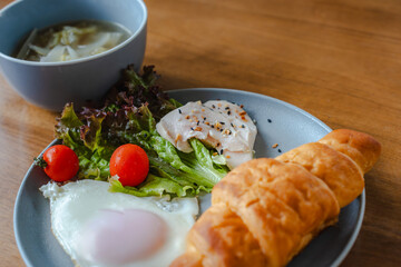 Healthy breakfast with croissant and salad
