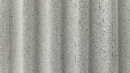 Fototapeta premium Gray corrugated fiber cement sheet texture background with vertical waves and weathered, rough surface.