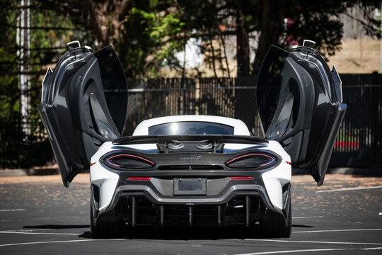 Portland, OR, USA-Aug 11, 2025- 2019 white McLaren 600 LT luxury sport super car parked outdoors. Track focused design with carbon fiber aero, rear wing spoiler, dihedral doors, ceramic brakes