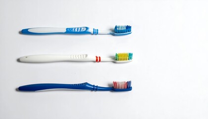 Three toothbrushes, various colors, on a white background