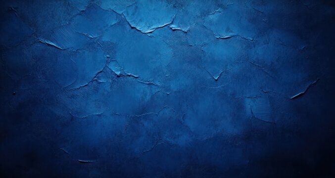 Dark blue textured surface with peeling paint and rough cracks creating an abstract and weathered effect