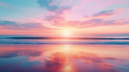 Calm ocean waves at sunset with pink and purple clouds reflecting on wet sand creating a peaceful and serene atmosphere