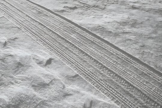 Close up of tire tracks imprinted in the sand on a beach