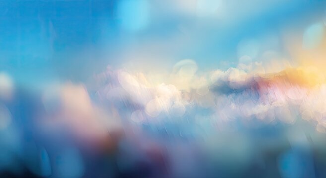 Abstract dreamy sky with clouds, blue, pink, and yellow hues, bokeh effect