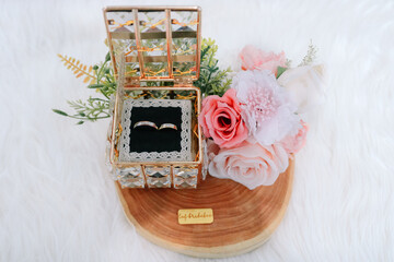 Luxury Wedding Rings in Crystal Box with Pink Roses on Wooden Base