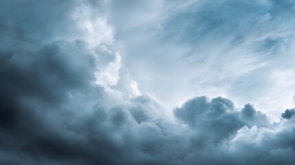 Obraz premium Dramatic cumulonimbus cloud formations fill the moody sky with intense shadow and light contrasts.
