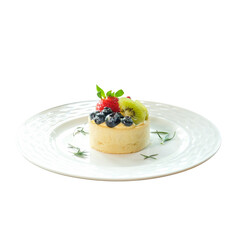 A delightful fruit tart featuring an array of fresh berries and kiwi, artfully arranged on a decorative plate