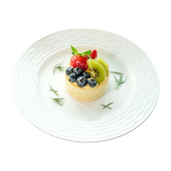 A delicious and vibrant fruit tart dessert on a plate, featuring fresh berries and kiwi. The tart looks visually appealing and appetizing.