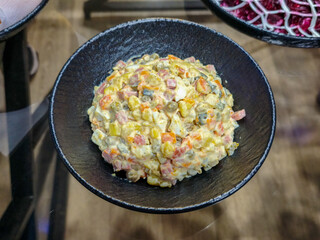 Russian Olivier salad in a black plate