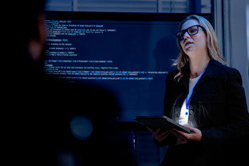 A female software architect presents the system architecture or walks through a complex codebase on...