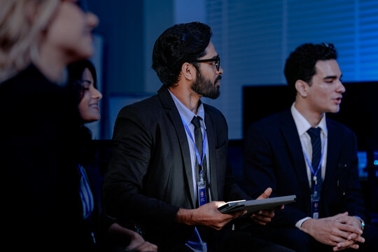 A diverse IT team, including an Indian man and woman, in an urgent security briefing. They are focused, listening to an update on a critical data incident or system failure. - Powered by Adobe