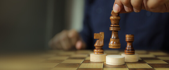 Hand chooses king chess for leadership business strategy plan or wining challenge and team player and risk management or human resource or strategic planning.