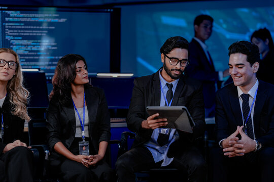 A company-wide strategy meeting on digital transformation. A large, diverse team of leaders discusses new AI solutions and sustainable ESG goals for future growth. - Powered by Adobe