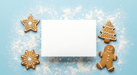 Gingerbread cookies and blank card arranged on light blue surface with flour create festive holiday scene for seasonal greetings and messages.