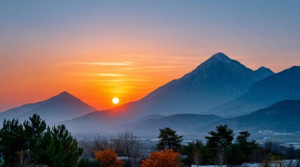 Sun setting behind a mountain range creating a vibrant sky
