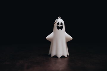Adorable Miniature Ghost Decoration on Dark Background for Halloween Festivities and Seasonal Home Decor Inspiration