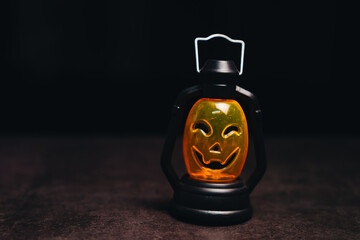 Vintage lantern with a spooky pumpkin face illuminating the darkness, perfect for Halloween...