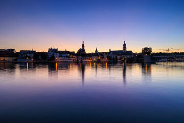 Kitzingen cityscape at sunset reflected in the Main River.