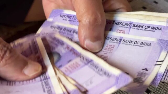 Counting 100 indian rupee notes