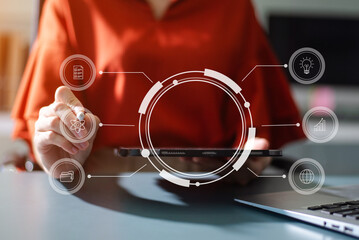 Businesswoman uses a tablet to analyze data on a virtual interface, symbolizing business innovation, technology, and global connection